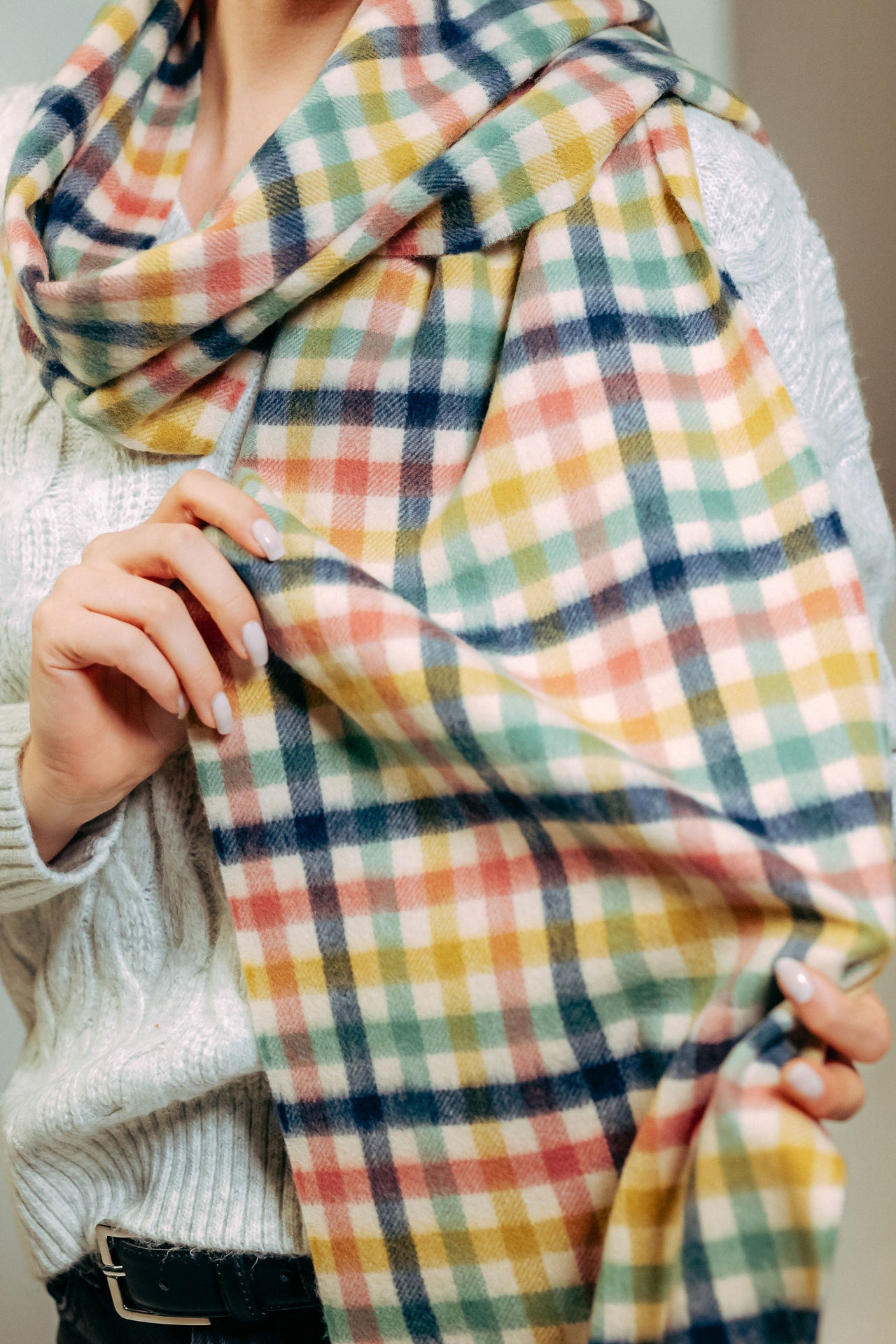 model wearing a colorful plaid scarf 