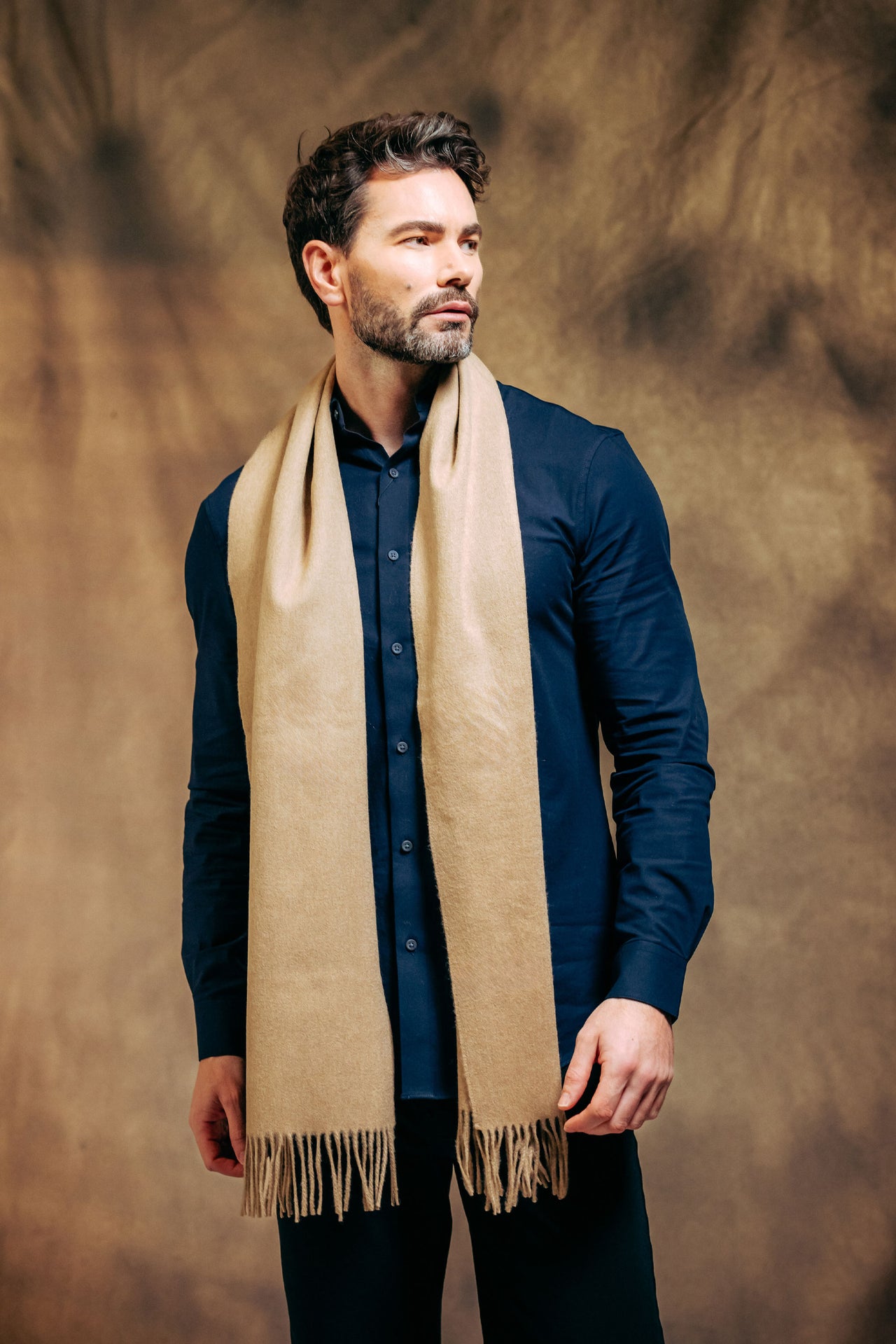 British male model wearing 100% Lambswool Scarf - Sand colour